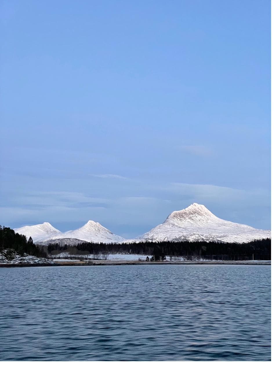 Heilhornet and mountain peaks across the fjord in winter