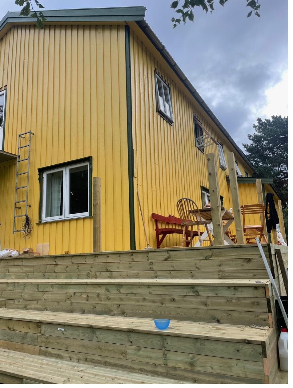 Yellow house exterior with wooden deck