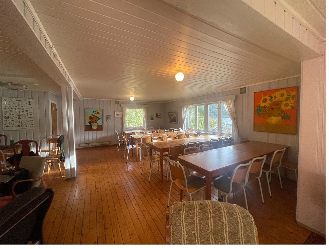 Gathering room with tables and sunflower paintings