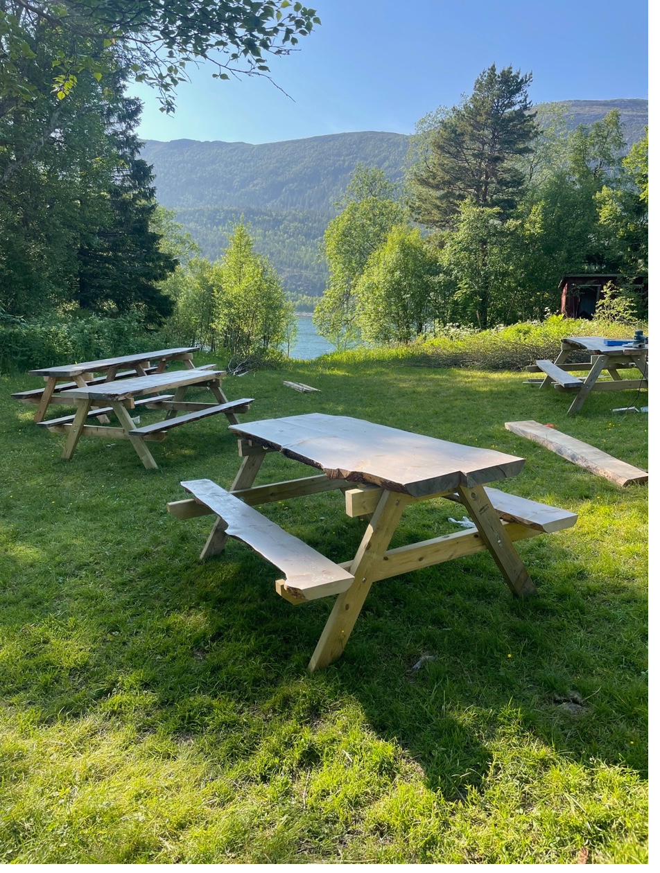 Outdoor picnic tables with fjord view